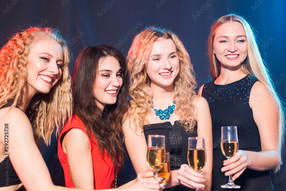 Birthday party, new year and holidays concept - Cheerful female friends celebrating with glasses of champagne