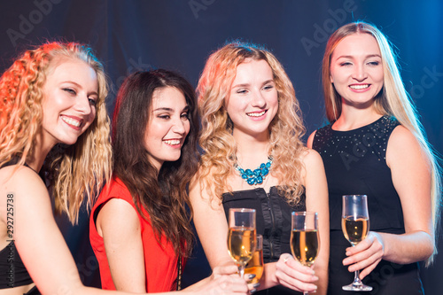 Birthday party, new year and holidays concept - Cheerful female friends celebrating with glasses of champagne
