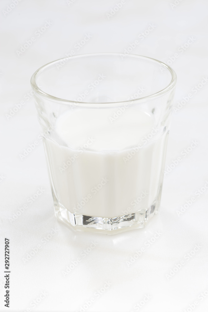 glass of milk on a white background, vertical, selective focus, closeup glass of milk on a white background, vertical, selective focus, closeup