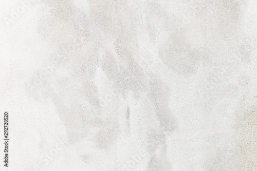 white washed painted concrete wall texture abstract background with brush strokes in gray and black shades.