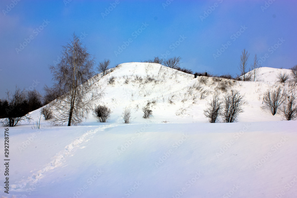 Winter: a snowy hill, a walk in nature, on the street