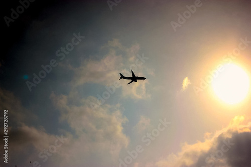 Flying plane against the sky at sunset