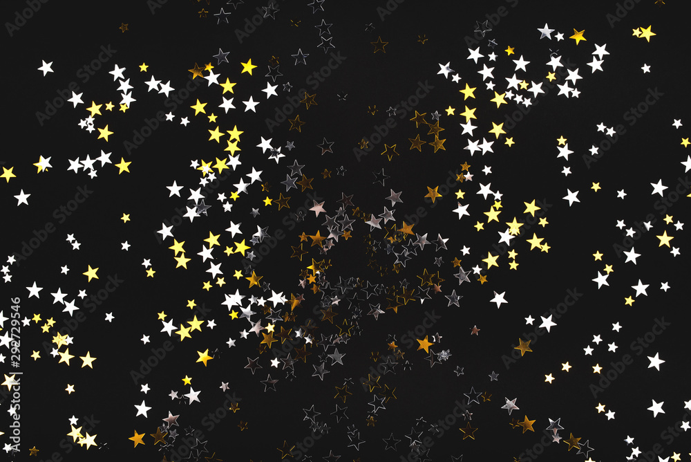 Golden and silver stars on black background. Flat lay, top view. Stock ...