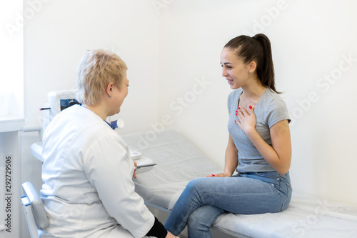 the doctor advises the patient's girl after an ultrasound diagnosis. indicates with a pen on the monitor of the ultrasound machine the problematic place to which the patient should pay special attenti photo