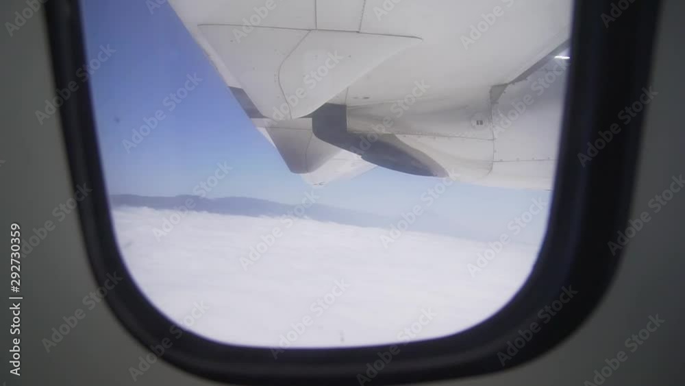 The view from the window - an airplane wing and a turbo engine in flight above the clouds. Air Transport The view from the window - an airplane wing and a turbo engine in flight above the clouds. Air Transport