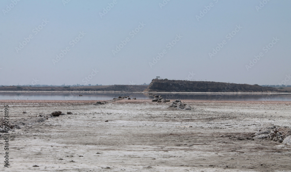 Panoramic view of Larnaca Salt Lake. Salt coast, lake water, mountains. Beautiful landscape. Panoramic view of Larnaca Salt Lake. Salt coast, lake water, mountains. Beautiful landscape.