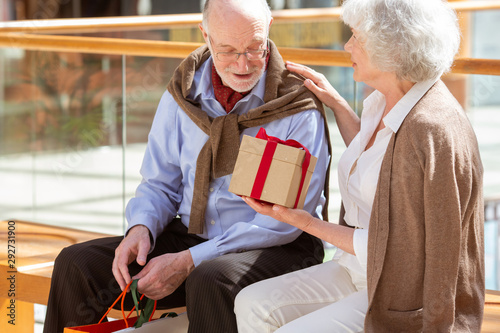 Senior couple with gift