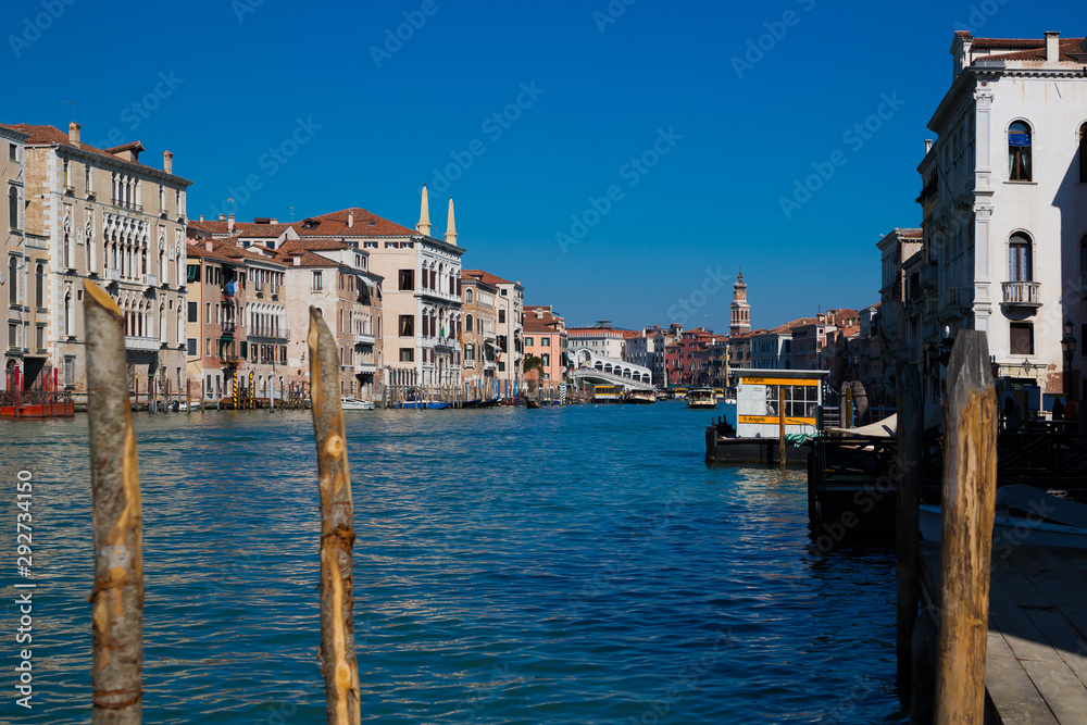 Famous landmark panoramic view Venice Italy with Bridge Rialto and blue sky and gondola boat water.