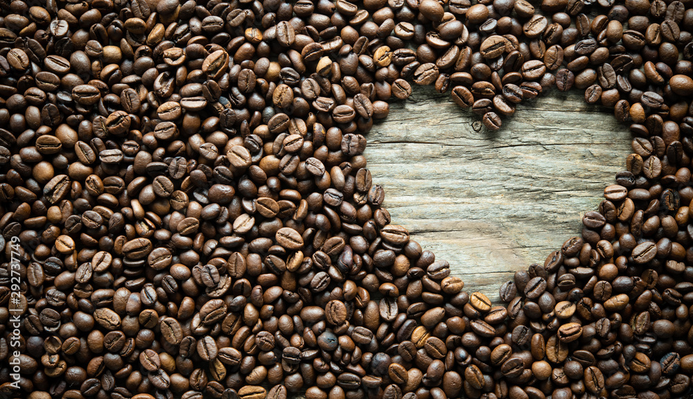 Coffee beans in heart shape on rustic wooden Coffee beans in heart shape on rustic wooden
