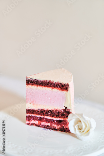 sweet piece of cake on a plate. A piece of wedding cake. photo