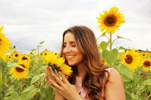 Beautiful woman in a sunflower field photo