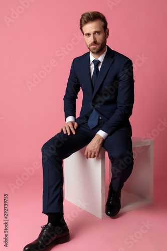 Картината върху платно businessman sitting with resting hands and looking at camera relaxed