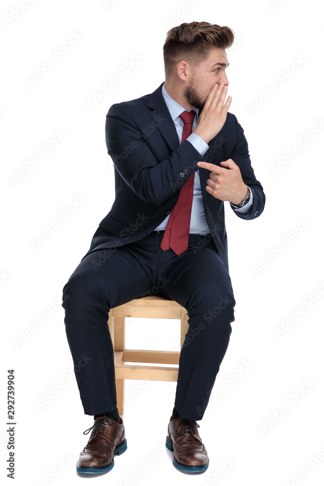 happy young businessman whispering on white background in studio happy young businessman whispering on white background in studio