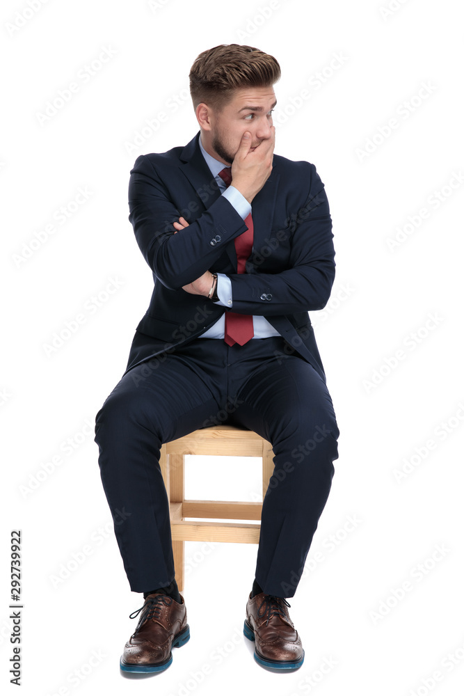 shocked young businessman covering mouth with hand shocked young businessman covering mouth with hand