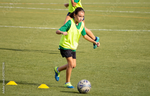 Little girl in a soccer training