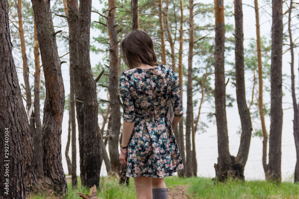 Young woman irunning through a forest at night, looking back Young woman irunning through a forest at night, looking back