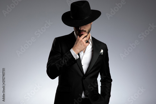 mysterious young man wearing tuxedo and black hat © Viorel Sima