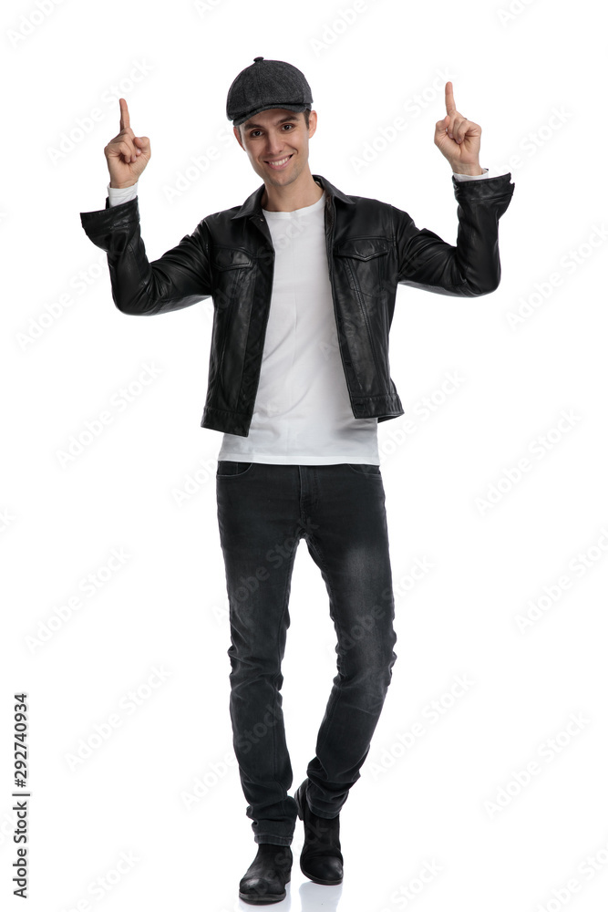 casual man standing and pointing up with both hands casual man standing and pointing up with both hands