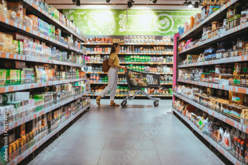 Foto woman with shopping between store shelf