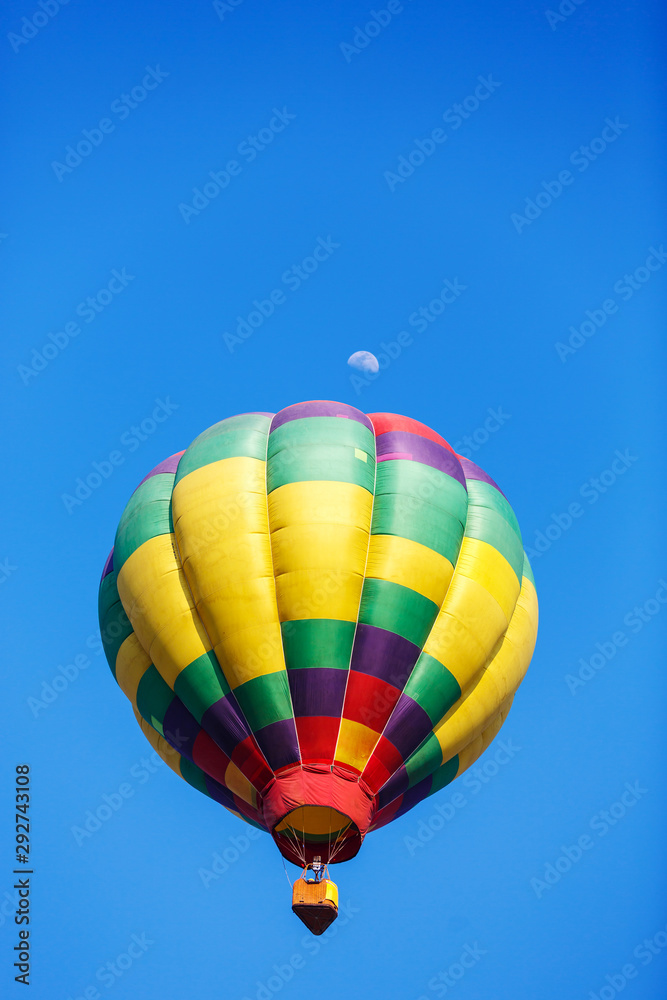 Obraz premium colorful hot air balloon with moon in blue sky