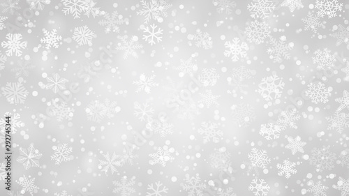 Christmas background of snowflakes of different shapes, sizes and transparency in gray colors