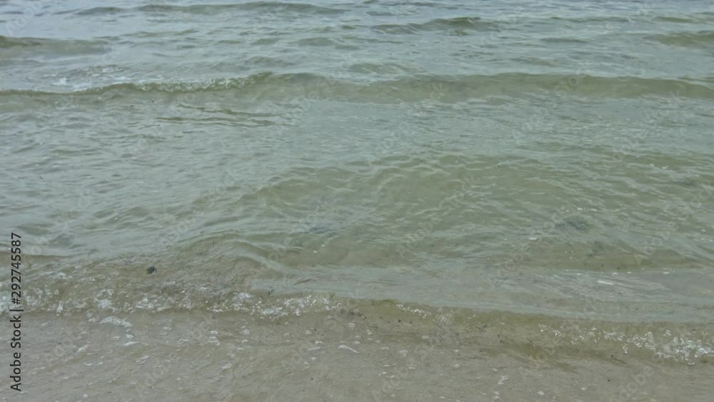 Slender fit woman in blue bikini runs into the ocean. Slow motion footage shot during day time. Slender fit woman in blue bikini runs into the ocean. Slow motion footage shot during day time.