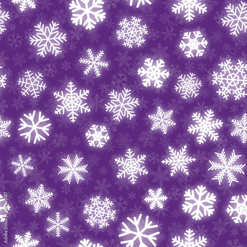 Christmas seamless pattern of white snowflakes of different shapes on purple background