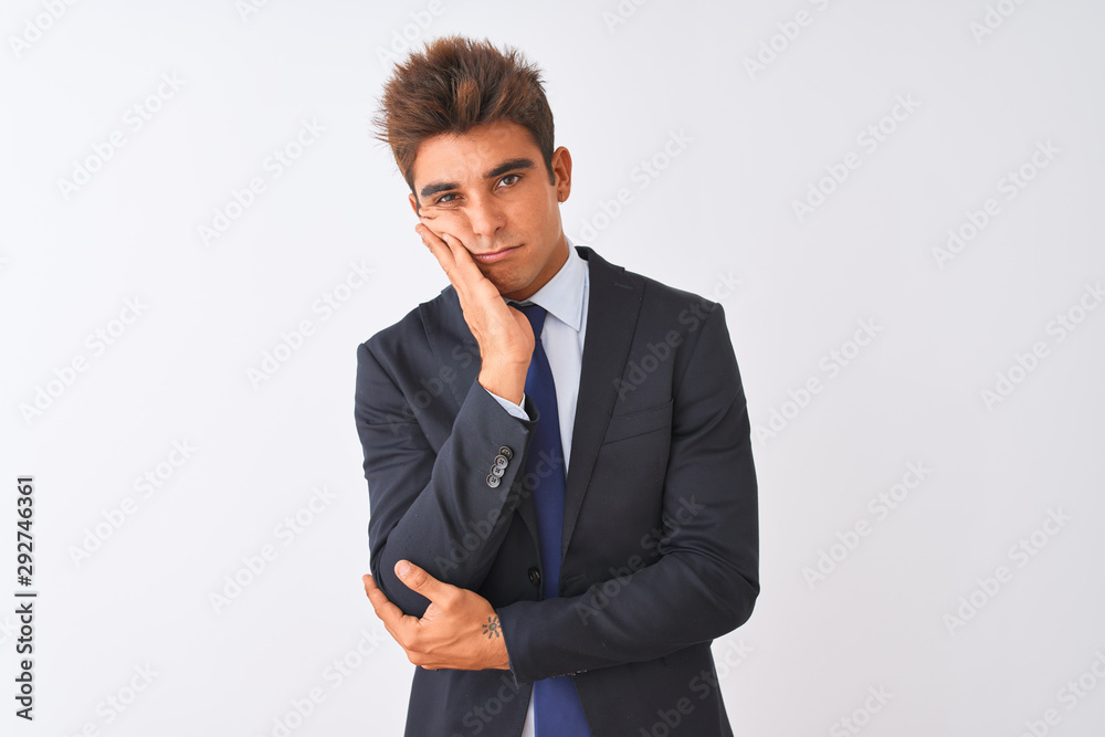 Young handsome businessman wearing suit standing over isolated white background thinking looking tired and bored with depression problems with crossed arms. Young handsome businessman wearing suit standing over isolated white background thinking looking tired and bored with depression problems with crossed arms.