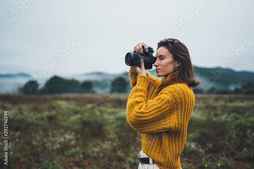 Obraz na płótnie photographer traveler take photo on video camera closeup on background autumn foggy mountain, tourist shooting nature mist landscape outdoor, hobby adventure concept, copy space mockup w salonie