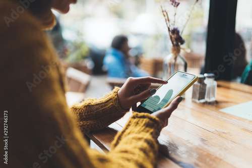 girl hold in hands mobile phone empty screen, person type message on smartphone cafe, tourist travels planning trip, hipster enjoy journey in cityscape, lifestyle holiday concept, internet online