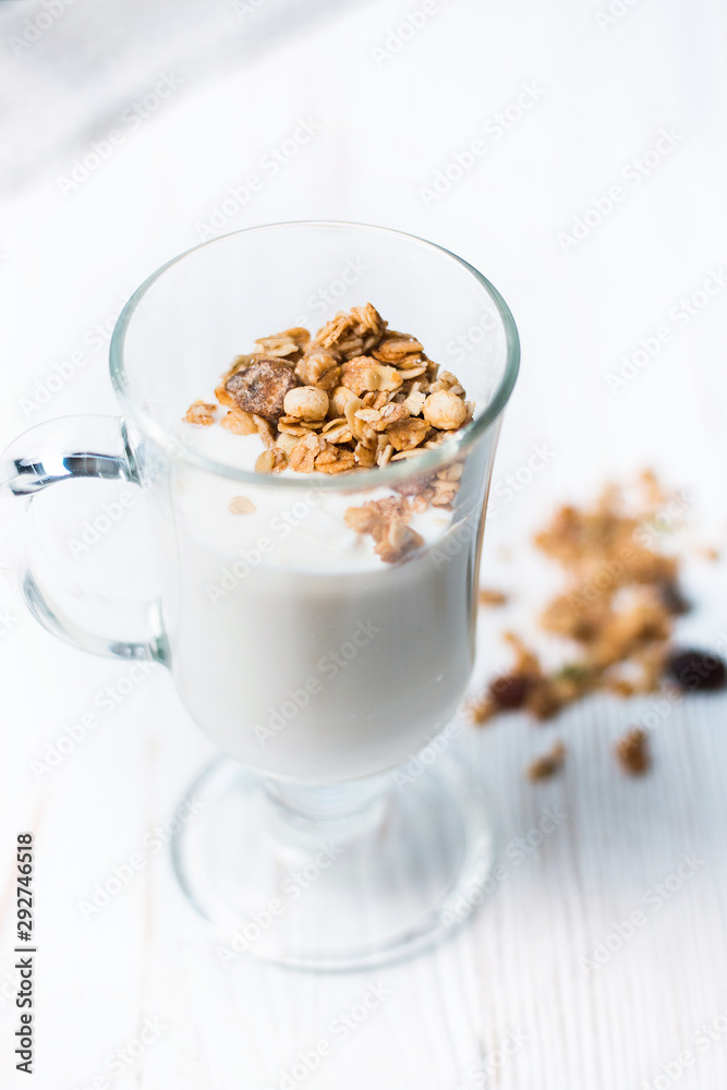 Crispy muesli in a glass with fresh yogurt, morning Breakfast, light snacks. Breakfast cereals isolated on white background, selective focus, top view Crispy muesli in a glass with fresh yogurt, morning Breakfast, light snacks. Breakfast cereals isolated on white background, selective focus, top view