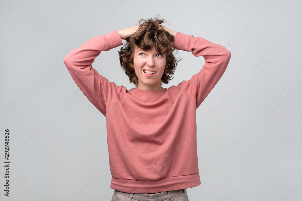 Smiling curly thinking woman looking up dreaming or planning Smiling curly thinking woman looking up dreaming or planning