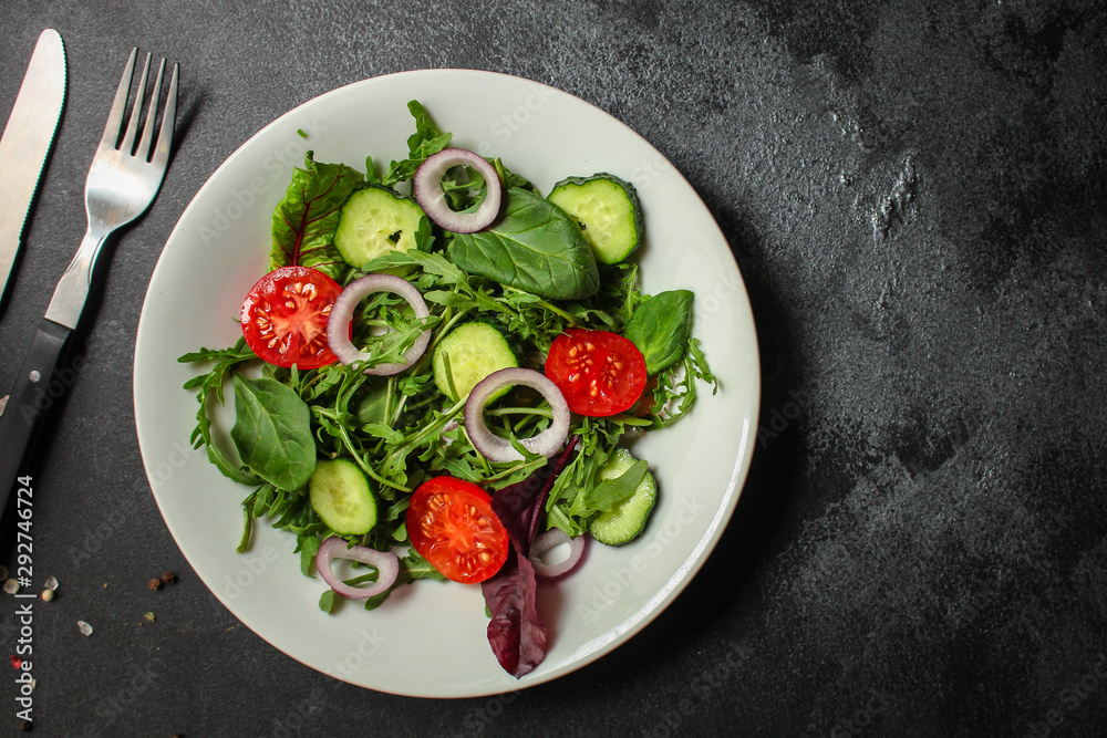 Healthy salad, leaves mix salad (mix micro greens, cucumber, tomato, onion, other ingredients). food background. copy space Healthy salad, leaves mix salad (mix micro greens, cucumber, tomato, onion, other ingredients). food background. copy space