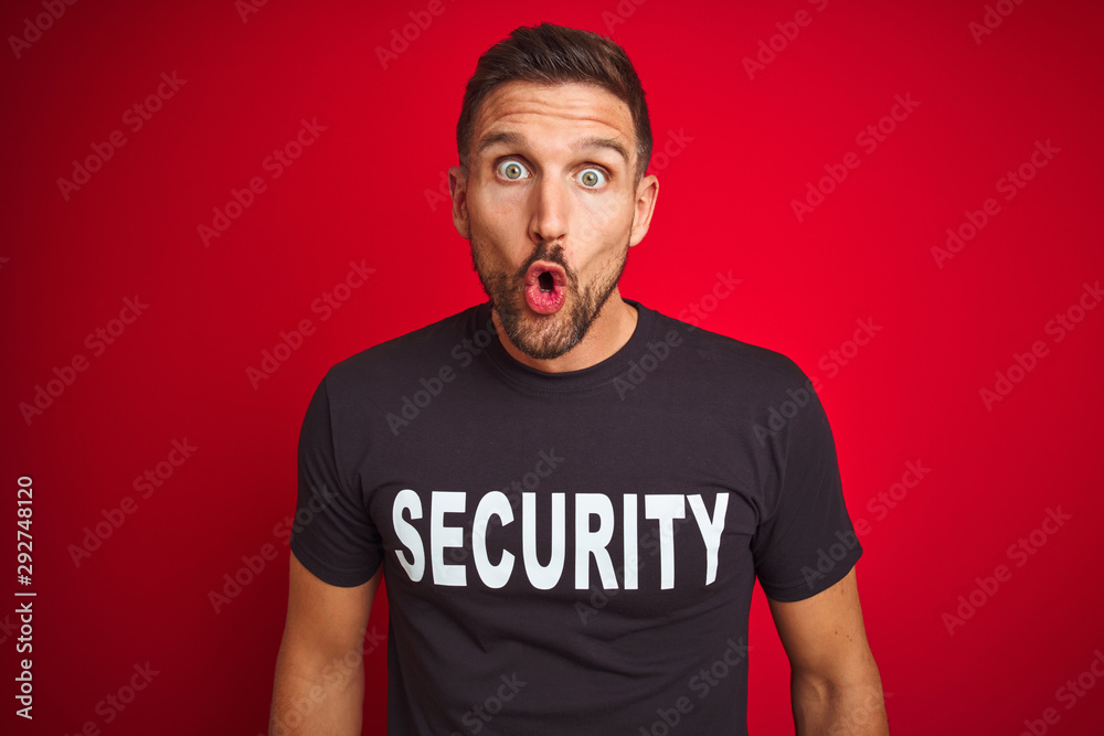 Young safeguard man wearing security uniform over red isolated background afraid and shocked with surprise expression, fear and excited face. Young safeguard man wearing security uniform over red isolated background afraid and shocked with surprise expression, fear and excited face.