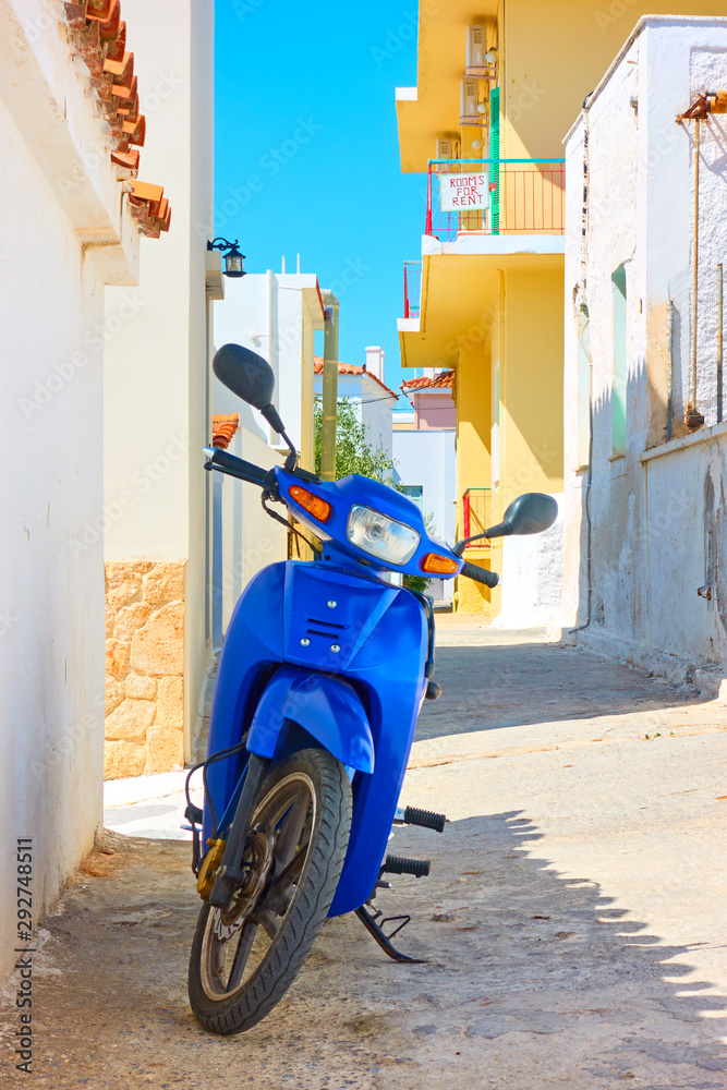 Street with parked scooter in Aegina Island