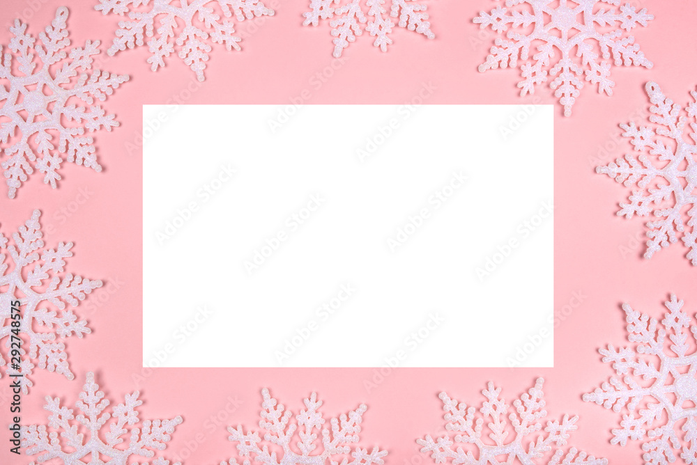 Winter pattern made of snowflakes and on pink background. Christmas concept. Flat lay. Copy space for your text.