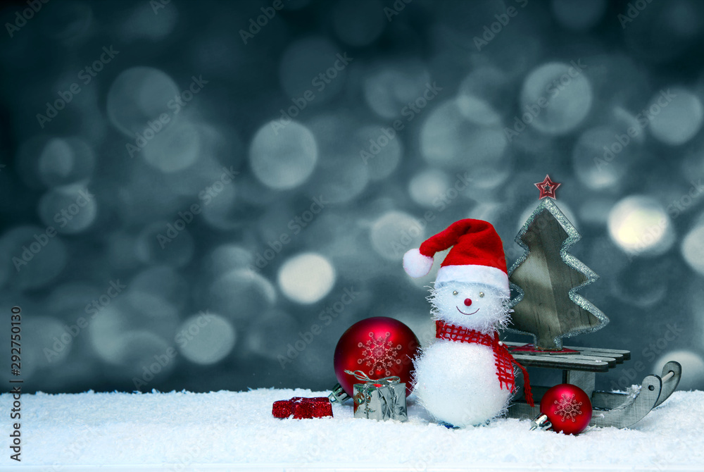 New Year 2020. Snowman with santa claus hat on snow .