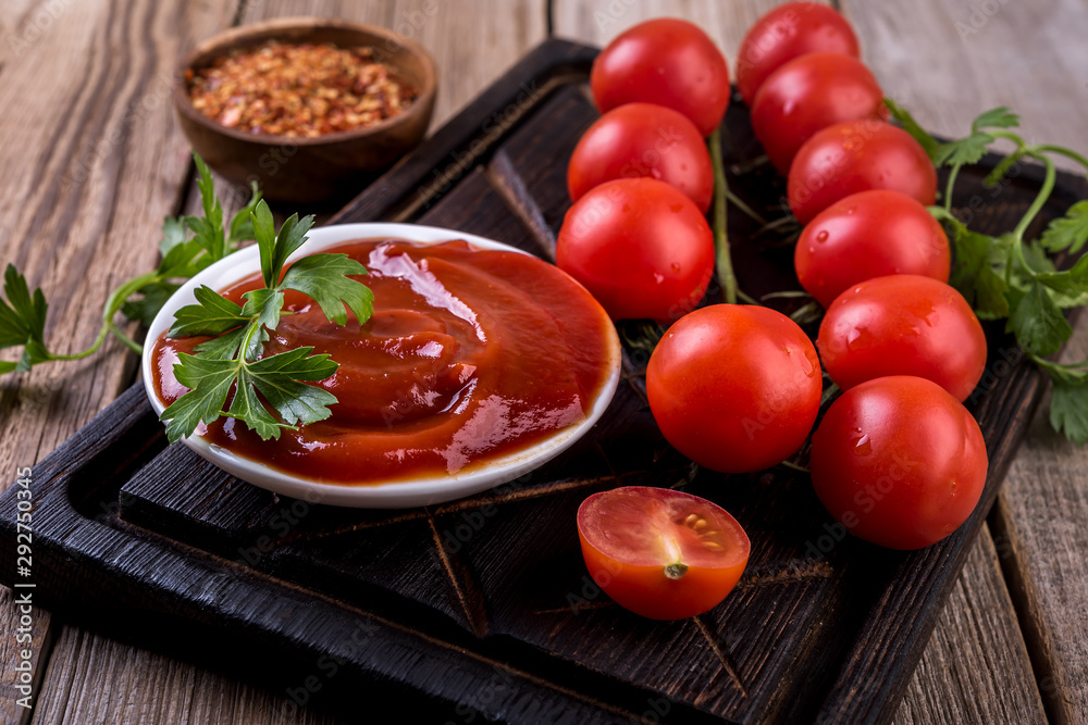 tomato sauce and fresh tomatoes on wooden table tomato sauce and fresh tomatoes on wooden table