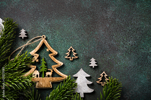 Festive background with wooden christmas tree and decoration. Copy space, winter holidays greeting card, flat lay, top view. photo