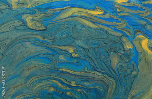 art photography of abstract marbleized effect background. blue and gold creative colors. Beautiful paint.