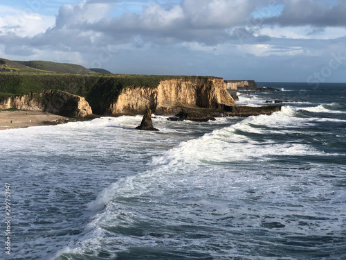 waves crashing below cliffs