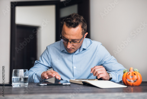 Businessman using a digital tablet at his neat office desk