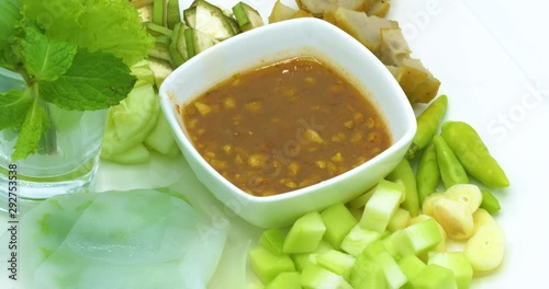 Vietnamese meatballwraps (Nam Neung) recipe rotating on white background, healthy food concept. photo
