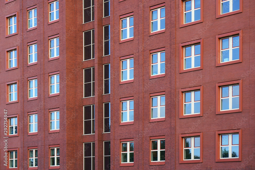 Facade of office building with windows. Facade of an old red brick wall with windows. Old red brick wall with windows.
