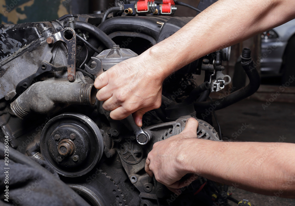 Car service - Engine repair mechanic hands with wrench generator nut Stock  Photo | Adobe Stock