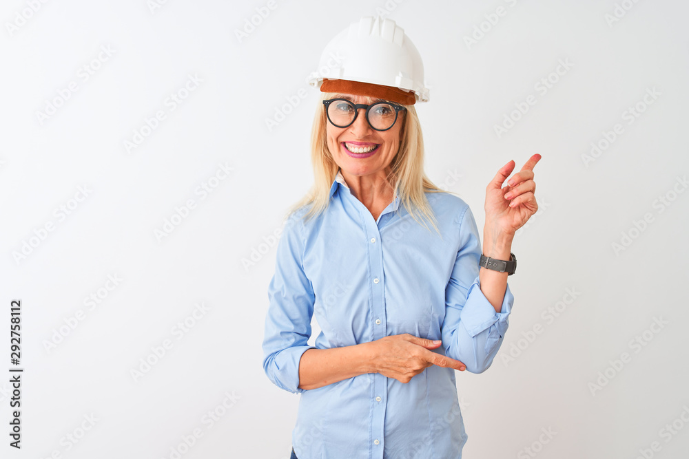 Middle age architect woman wearing glasses and helmet over isolated white background with a big smile on face, pointing with hand and finger to the side looking at the camera. Middle age architect woman wearing glasses and helmet over isolated white background with a big smile on face, pointing with hand and finger to the side looking at the camera.