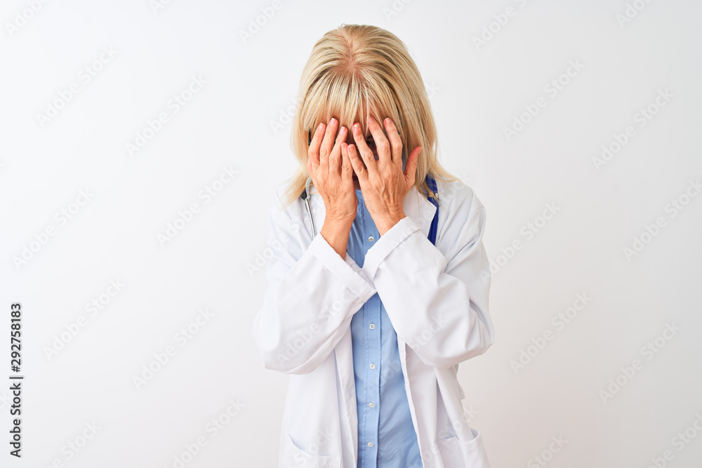 Middle age doctor woman wearing glasses and stethoscope over isolated white background with sad expression covering face with hands while crying. Depression concept. Middle age doctor woman wearing glasses and stethoscope over isolated white background with sad expression covering face with hands while crying. Depression concept.