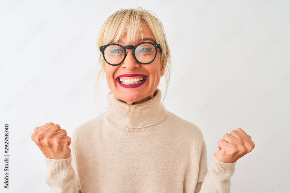 Middle age woman wearing turtleneck sweater and glasses over isolated white background celebrating surprised and amazed for success with arms raised and open eyes. Winner concept. Middle age woman wearing turtleneck sweater and glasses over isolated white background celebrating surprised and amazed for success with arms raised and open eyes. Winner concept.
