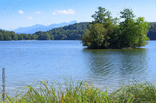 Picturesque view of small lake with wooded islet