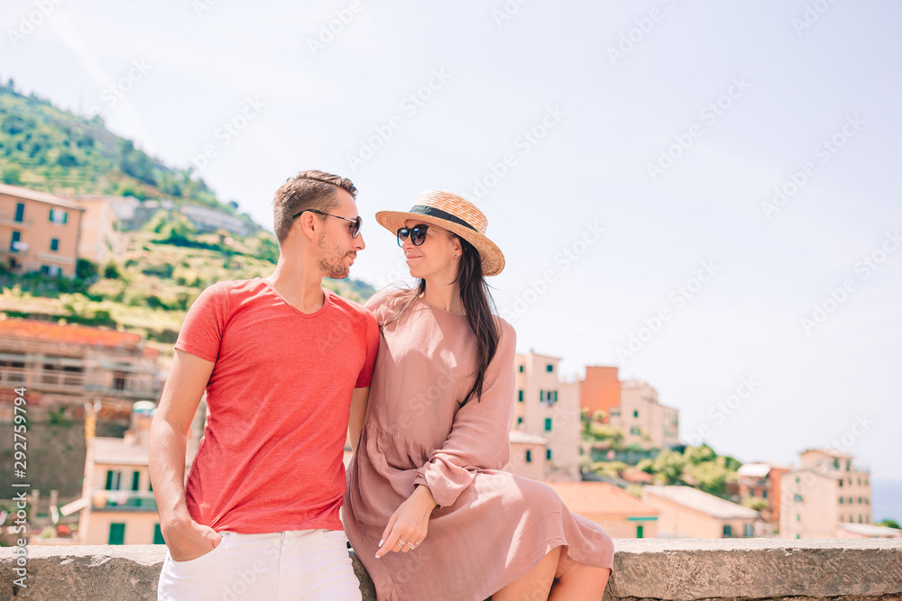 Tourists looking at scenic view of Riomaggiore, Cinque Terre, Liguria, Italy